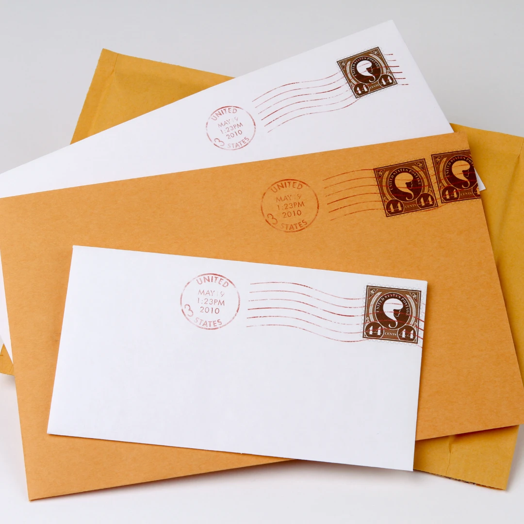 Three old US envelopes with postage stamps.